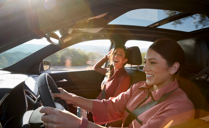 Happy people driving a GM vehicle