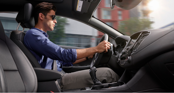 Guy driving GM vehicle with sunglasses