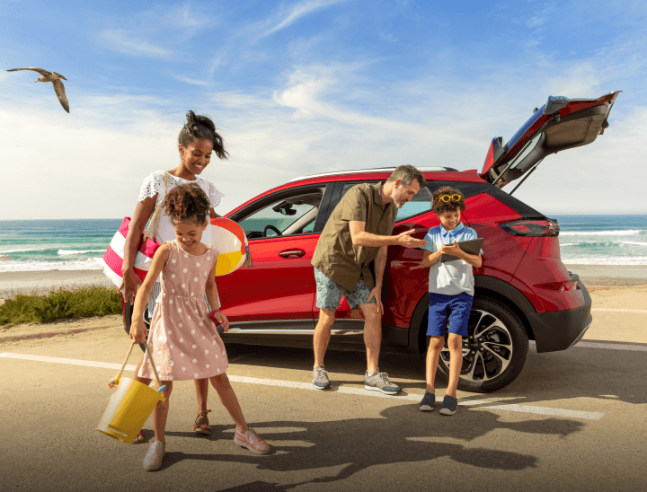 Family at beach with GMC vehicle